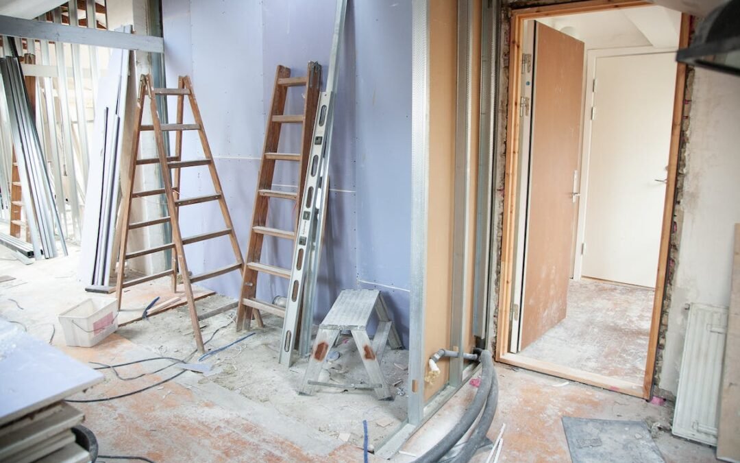 A room that is being remodeled with a ladder for Hauling Services.